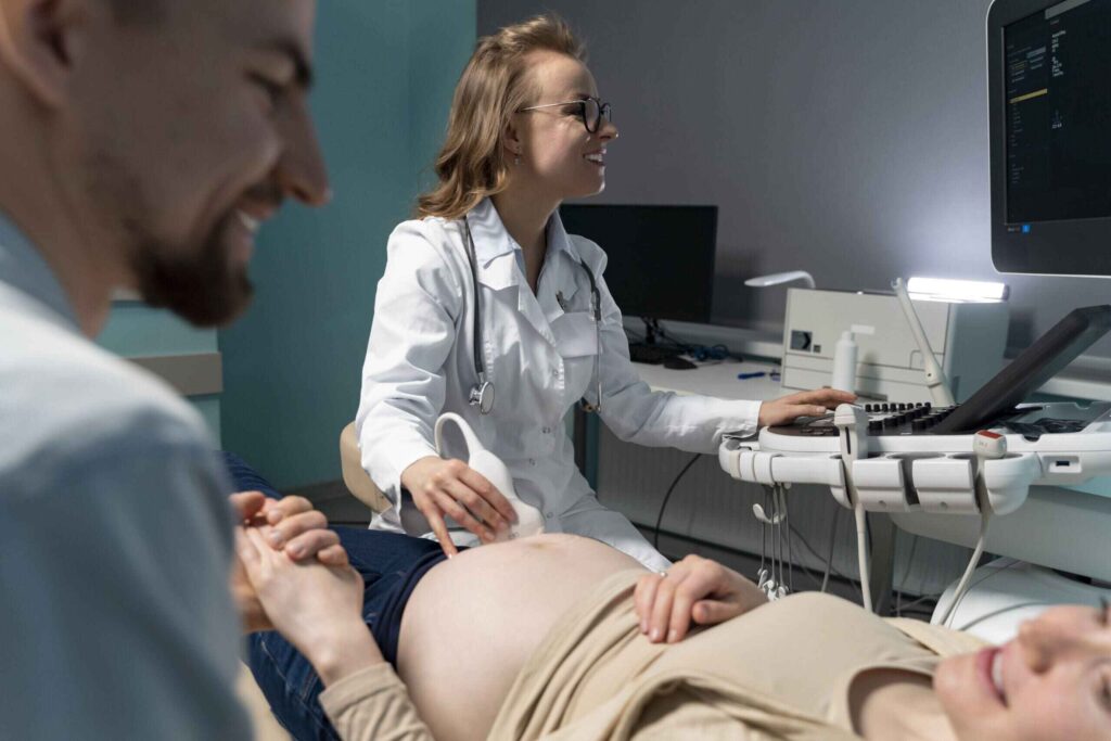 Gynecologist conducting ultrasound scan for pregnant woman
